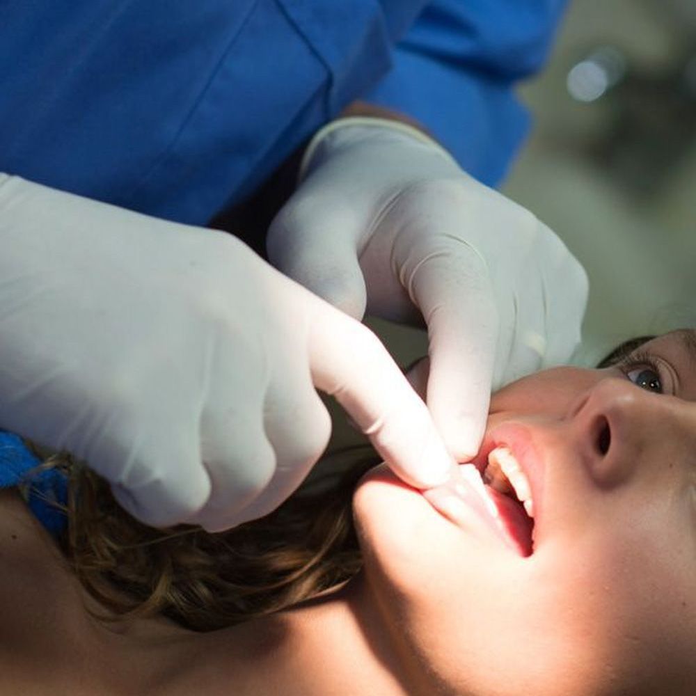 A woman undergoing an oral cancer screening